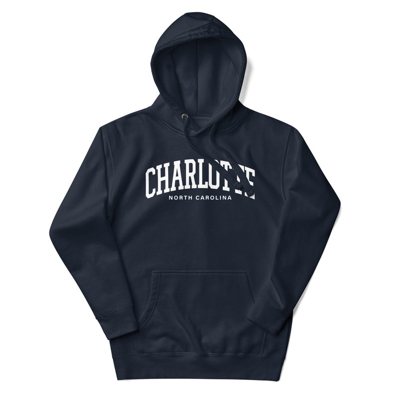 May include: A navy blue hooded sweatshirt with a white arch design that says "CHARLOTTE NORTH CAROLINA".