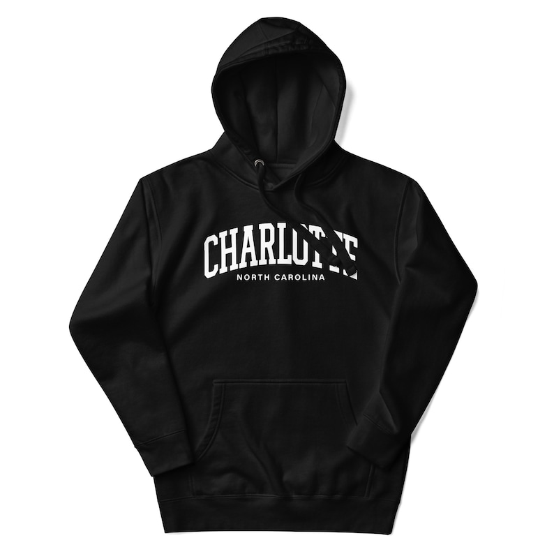 May include: Black hooded sweatshirt with white text that reads "CHARLOTTE NORTH CAROLINA" in an arched font.