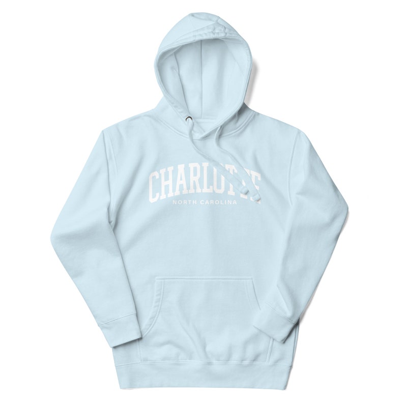 May include: Light blue hooded sweatshirt with white text that reads "CHARLOTTE NORTH CAROLINA".