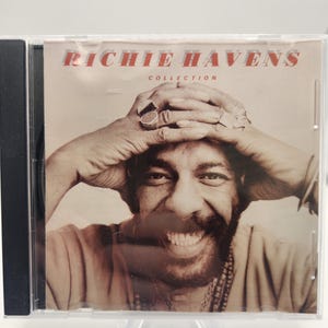 May include: A CD case featuring the album "Collection" by Richie Havens. The cover art displays a sepia-toned portrait of the musician with his hands on his head. The text "RICHIE HAVENS" is in red, and "COLLECTION" is in a smaller font.