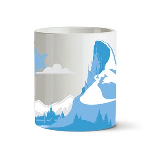 May include: White ceramic mug with a blue and white illustration of a mountain range with a castle on top. The illustration also includes a snowflake and a cloud.