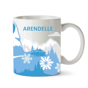 May include: White ceramic mug with a blue and white design featuring a snowy mountain scene, a small cabin, and snowflakes. The text "ARENDELLE" is printed on the mug.