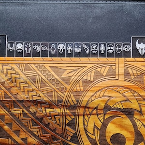 May include: A wooden box with a carved design on the top. The design is a combination of geometric shapes and swirls. The box is made of light and dark wood, giving it a natural and rustic look.