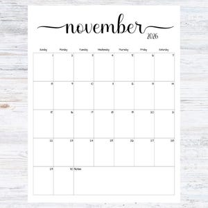 May include: A white calendar page for November 2026. The word "november" is written in cursive script above the calendar grid. The days of the week are listed across the top, with dates filling the grid. The bottom has a space for notes.