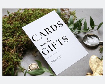 May include: White card with black text that reads "Cards and Gifts" with the words "Thank You" at the bottom.