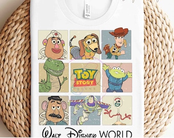 May include: A white t-shirt with a vintage-style design featuring characters from the Toy Story franchise. The design includes Woody, Buzz Lightyear, Rex, Mr. Potato Head, Slinky Dog, and Forky. The text "Toy Story Designs" is included in the design. The text "Walt Disney World Ready to Press Transfers" is at the bottom of the shirt.