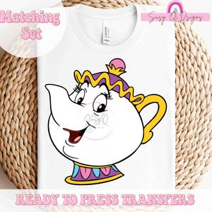 May include: A white iron-on transfer design featuring a cartoon teapot with a pink lid, purple and yellow trim, and a smiling face. The design is ready to press onto fabric.