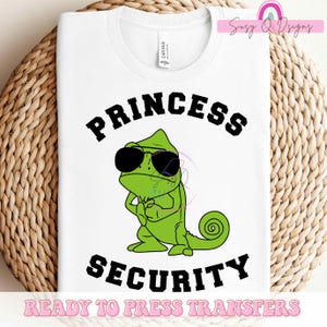 May include: White t-shirt with a green chameleon wearing sunglasses and the text "Princess Security" in black. The text "Ready to Press Transfers" is at the bottom of the shirt.
