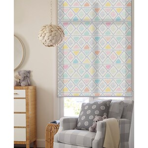 May include: A white window shade with a colorful geometric pattern featuring blue, yellow, pink, and green triangles and diamonds. The pattern is repeated throughout the shade.