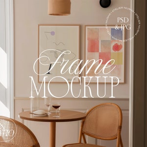 May include: A mockup of a dining room setting with two framed artworks, a small round table, and two rattan chairs. The frames display abstract art. The table is set with glassware and a small plate. The text "Frame MOCKUP" is overlaid on the image.