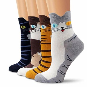 May include: Four pairs of cat-themed socks in various colors. Each sock features a different cat face design, including a black cat, a brown and white cat, a yellow and brown striped cat, and a gray and white cat. The socks are displayed on legs.