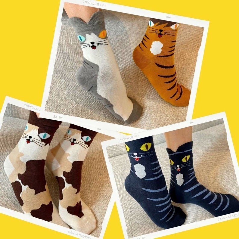 May include: Four pairs of cat-themed socks in various colors. One pair is gray and white, another is orange with black stripes, and two pairs are brown and white. The last pair is navy blue with light blue stripes.