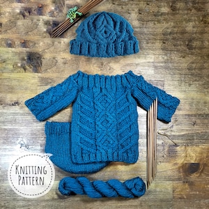 May include: Knitting pattern for a blue baby sweater, hat, and booties. The pattern includes instructions for a cable knit design. The yarn is also pictured.