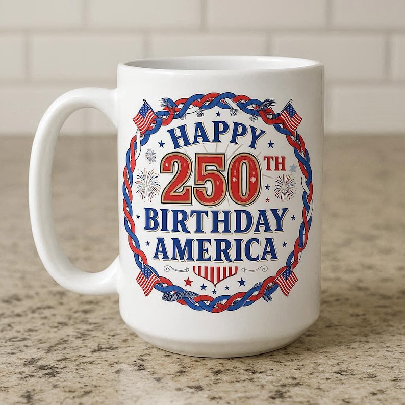May include: White ceramic mug with a patriotic design celebrating America's 250th birthday. The mug features the text "HAPPY 250TH BIRTHDAY AMERICA" in red, white, and blue, with decorative elements like flags and fireworks.