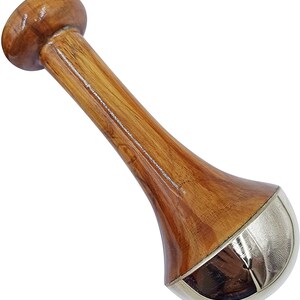 May include: A wooden pestle with a rounded top and a flared base. The pestle is made of polished wood with a natural grain and a silver-colored metal band at the base. The pestle is designed for grinding and mixing ingredients.