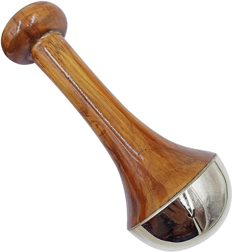 May include: A wooden pestle with a rounded top and a flared base. The pestle is made of polished wood with a natural grain and a silver-colored metal band at the base. The pestle is designed for grinding and mixing ingredients.