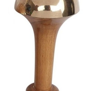 May include: A decorative bottle stopper with a polished brass dome and a wooden stem. The stem is a light brown color and has a flared shape. The base of the stopper has a rounded design.