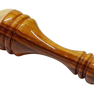May include: A wooden wax seal stamp with a polished finish. The stamp features a light brown wooden handle and a gold-colored, rounded top. The handle has a layered design with a smooth, glossy appearance.