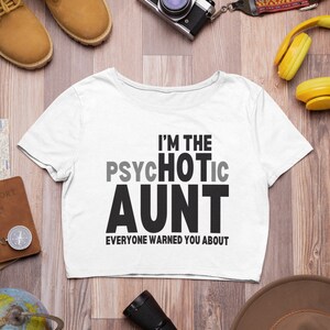 May include: White cropped t-shirt with black text that reads "I'm the Psychotic Aunt Everyone Warned You About."