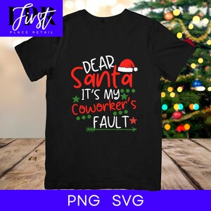 May include: Black t-shirt with the text "DEAR SANTA IT'S MY Coworker's FAULT" in red, green, and white. The design includes a Santa hat and stars. The shirt is a Christmas-themed apparel item.