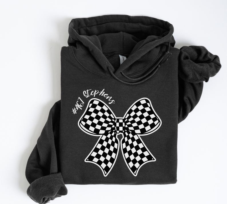 May include: Black hooded sweatshirt with a white checkered bow and the text "Stephens #407" printed on the front.