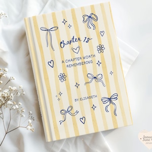 May include: A hardcover book with a cream and yellow striped cover. The cover features blue bow illustrations, hearts, and the text "Chapter 18, A chapter worth remembering, By: Elisabeth."