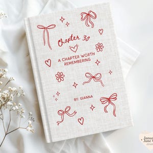May include: A light beige, textured hardcover book featuring red line art illustrations of bows, hearts, flowers, and stars. The cover text reads: Chapter 30, A CHAPTER WORTH REMEMBERING, and BY: GIANNA. The design is printed in a simple, clean style.