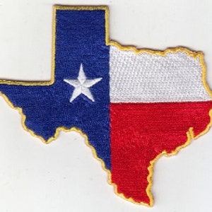May include: A blue, white, and red embroidered patch in the shape of the state of Texas. The patch has a gold outline and a white star in the blue section.