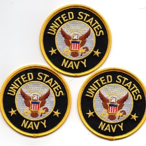 May include: Three circular embroidered patches with a black background and gold trim. Each patch features the words "UNITED STATES NAVY" in gold lettering, surrounding a central emblem of a brown eagle with a shield and the words "NAVY".