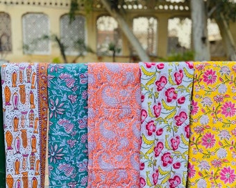 May include: Five colorful fabric panels with floral and geometric patterns. The panels are hanging on a clothesline.