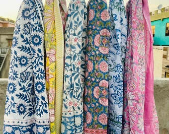 May include: Six colorful cotton scarves with floral patterns and stripes. The scarves are hanging on a clothesline.