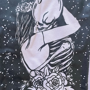 Hugging skeleton and girl.