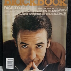 May include: A magazine cover featuring a man with dark hair and a brown jacket. The magazine title "Black Book" is in large orange letters at the top. The cover also includes text about the magazine's content, including "Face-to-Face" and other articles.