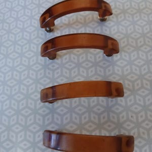 set of four brown bakelite arched drawer pulls, art deco