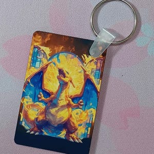 May include: A white ceramic mug with a black handle and the text "But First, Coffee" in a bold, black font. The mug is set against a blurred background, suggesting a cozy setting.