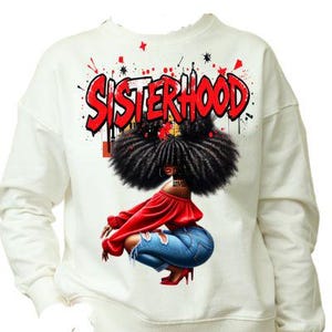 May include: White sweatshirt with a red graphic print of a woman with afro hair and the word "Sisterhood" in red letters.