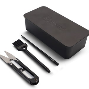 May include: A black sewing kit with a small pair of scissors, a brush, a chopstick, and a black rectangular storage box with the text "HABOTEST" on the top.