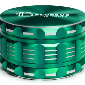May include: A green metal grinder with the text "Bluebus Fine Tools" on the top. The grinder has a silver trim and a textured design.