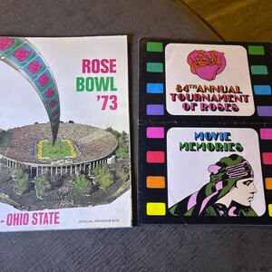 May include: Two vintage programs. The left program is for the Rose Bowl '73, featuring a stadium illustration and the USC-Ohio State game details. The right program is for the 84th Annual Tournament of Roses and Movie Memories.