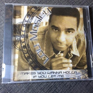 May include: A CD case with a photo of a man on the front. The text on the case reads "Lou Mosley Makes You Wanna Holla If You Let Me".