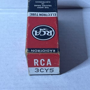 May include: A red and white box for an RCA 3CY5 Radiotron electron tube. The box has the RCA logo with a lightning bolt and the text "The Most Trusted Name in Electronics".