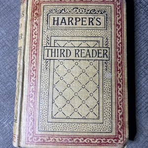 May include: A vintage book titled "Harper's Third Reader" with a decorative cover featuring a red and gold border and a patterned design.