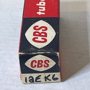 May include: A red and black box with the text "CBS tube" on the top and "CBS" and "1AE K6" on the bottom.