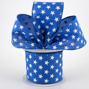 May include: A spool of blue and white ribbon with a white star pattern. The ribbon is 2.5 inches wide.