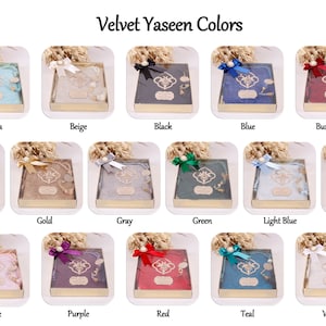 May include: A display of velvet Yaseen books in various colors, including aqua, beige, black, blue, burgundy, dark violet, gold, gray, green, light blue, navy blue, pink, purple, red, teal, and white. Each book is in a clear box with a decorative bow.