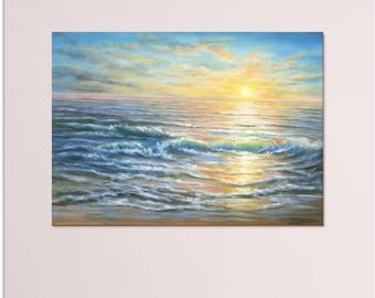 May include: An oil painting of a coastal sunset featuring a bright yellow sun on the horizon, soft blue and orange clouds, and gentle ocean waves rolling onto a sandy beach. The light reflects across the water surface in shades of gold and blue.
