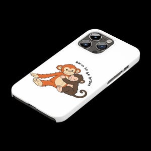 May include: White phone case featuring a cartoon illustration of two monkeys hugging. One monkey is orange, the other is brown. The text "born to be brave" is written in a script font.