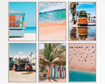 May include: Six framed photographs of beach scenes. The photos include a lifeguard stand, a beach with palm trees, a beach with surfboards, a beach with a yellow van, a beach with people, and a beach with waves crashing.