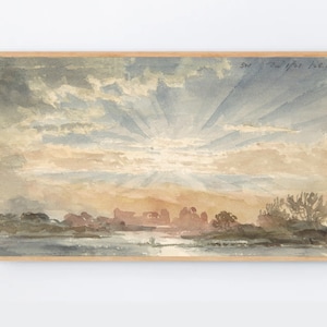 May include: A watercolor painting of a sunset over a body of water. The sky is filled with soft, pastel colors of pink, orange, and blue, with rays of light emanating from the sun. The water is a calm, reflective surface, and there are trees and bushes in the foreground.