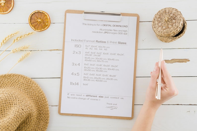 May include: A clipboard with a list of different print sizes for digital downloads. The list includes sizes like 5x7, 10x14, 4x6, 6x10, 12x18, 18x24, 20x30, 24x30, 10x20, 10x24, 15x20, 22x30, 30x40, 30x50, 45x80, 10x12, 20x25, 20x30, 30x30, 40x50, 8x14 inches. The clipboard is on a white wooden surface with a straw hat, wheat stalks, and dried orange slices.